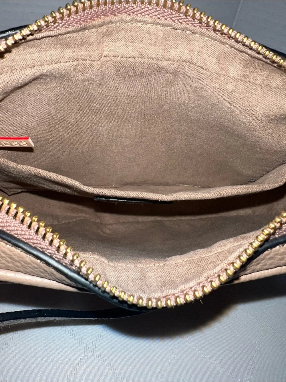 Designer inspired half-moon shoulder bag in a neutral taupe leather w/monogram